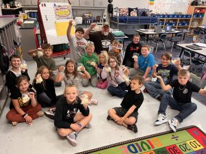 Mr. Reilly's 3rd grade class holding up bags of cauliflower to eat