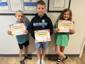 3 students holding their perfect attendance certificates