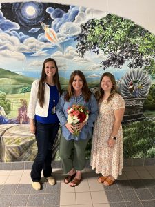 Principal and lead teacher standing with Riverbend Teacher of the Year, Ms. Carter