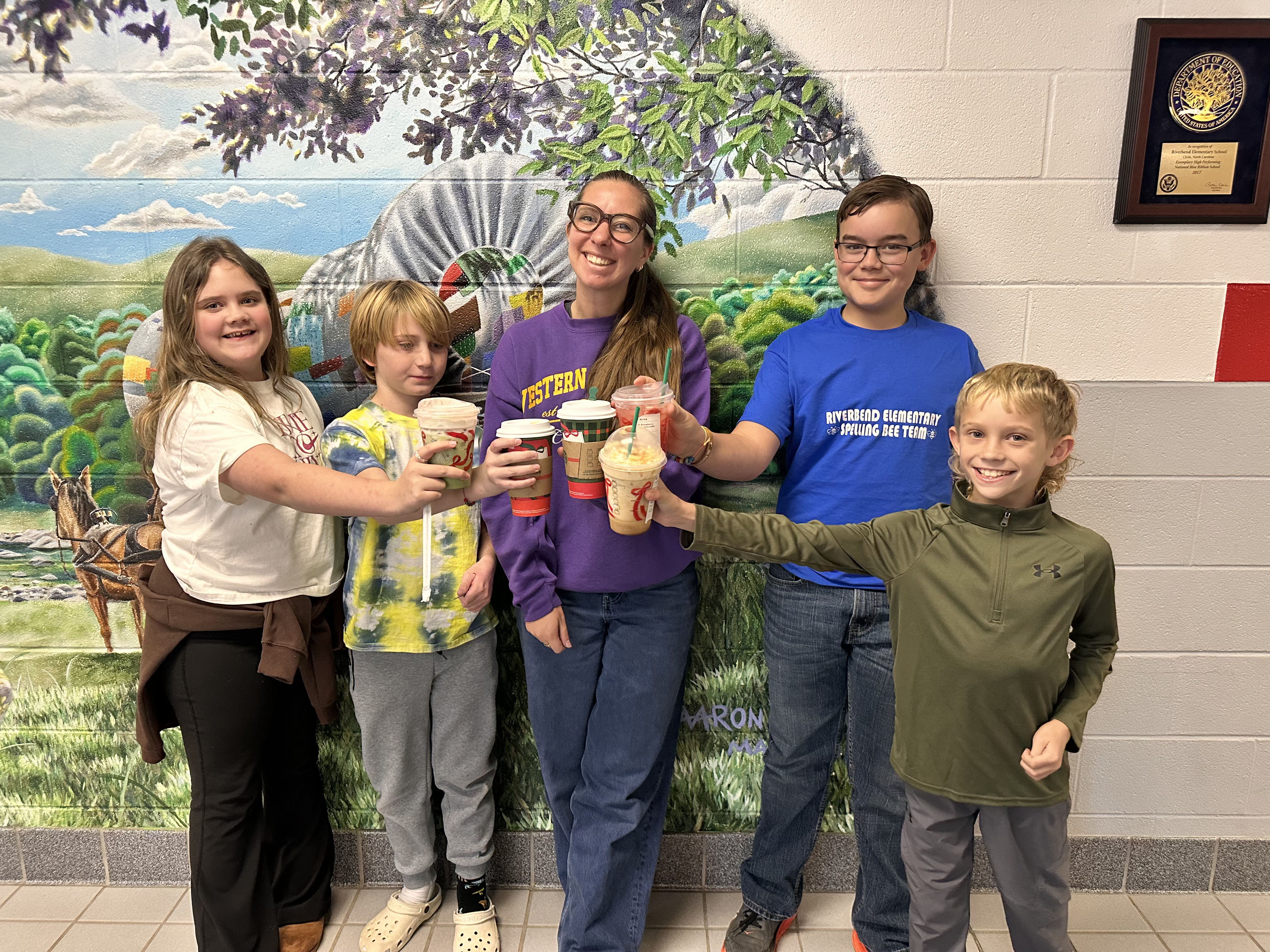 Four Spelling Bee students and their teacher Mrs. Willoughby cheering their Starbucks drink for a job well down at last night Spelling Bee.